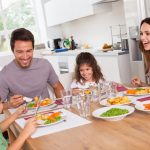 family-laughing-around-a-good-meal-in-kitchen