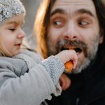 father-playing-with-his-baby-girl-on-winter-cold-sunset