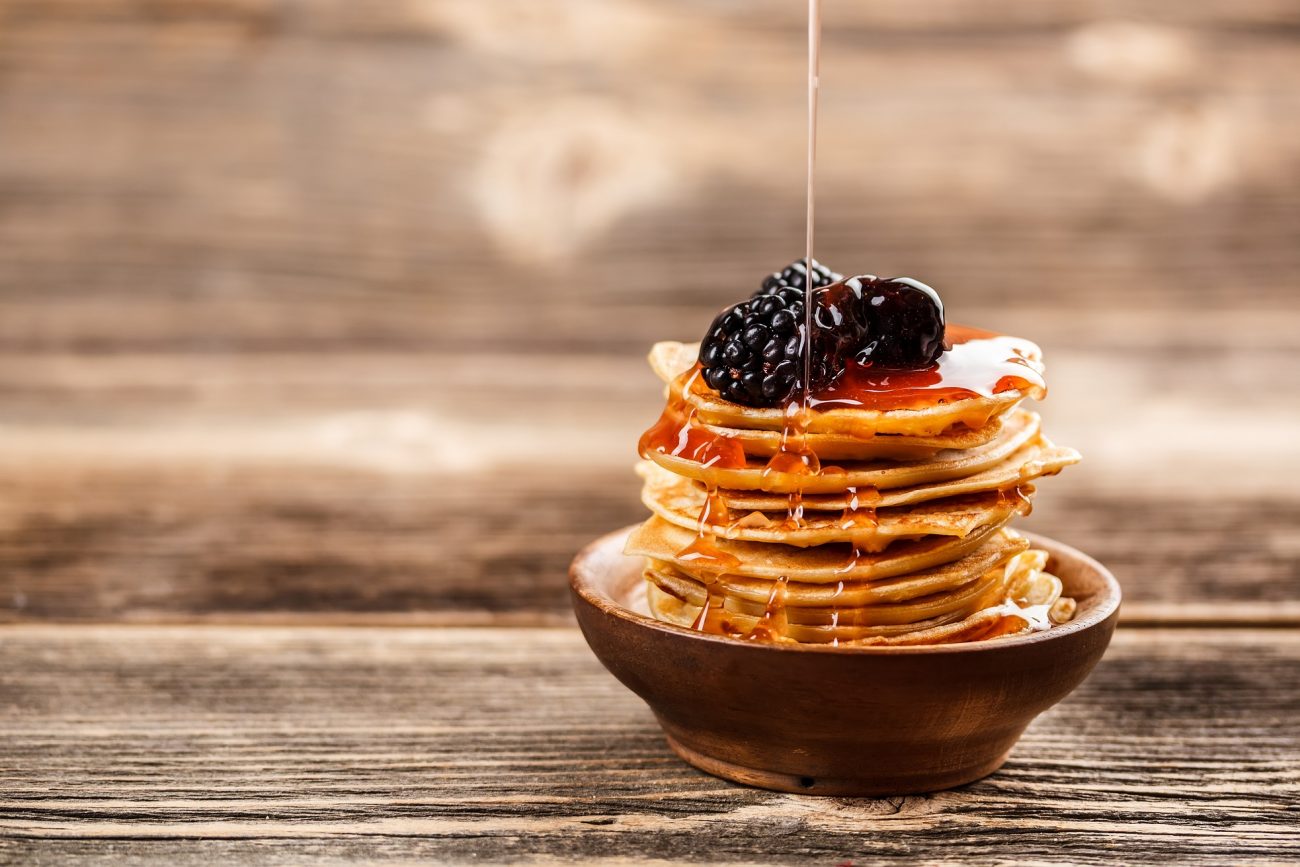 honey honey-pouring-over-a-stack-of-mini-pancakes