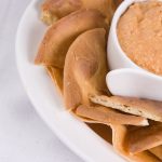 Appetizer tray with fresh hummus and toasted pita bread