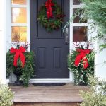 Front door with a Christmas wreath and bows