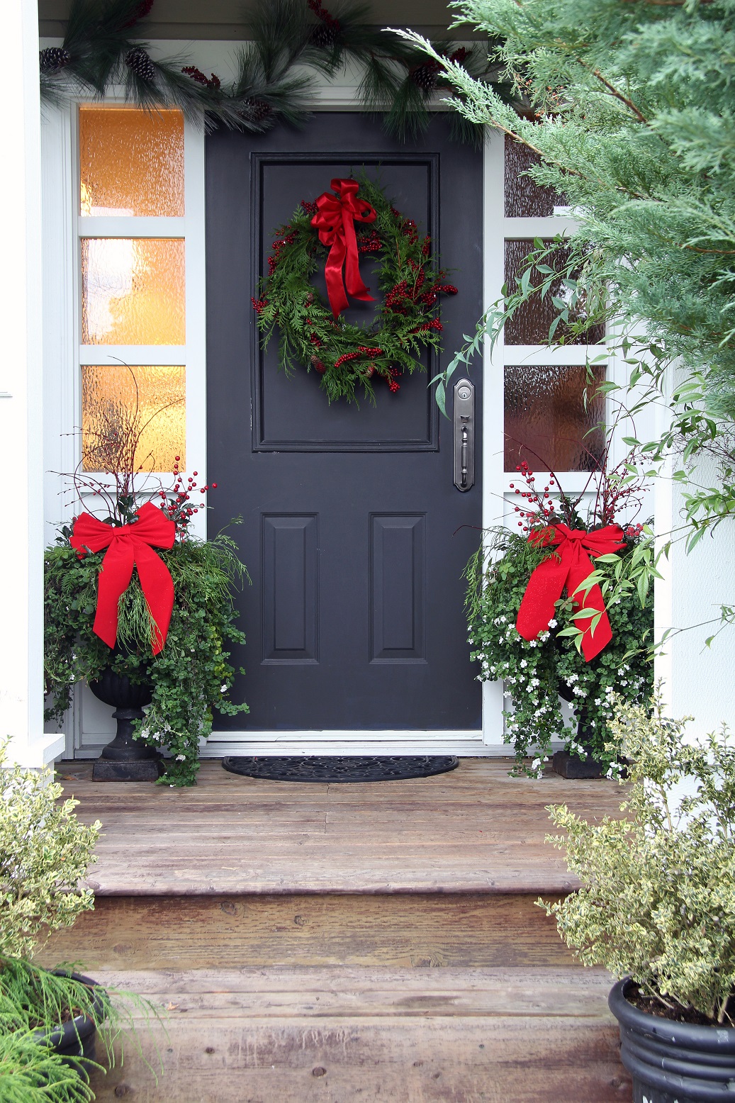 decorate Front door with a Christmas wreath and bows