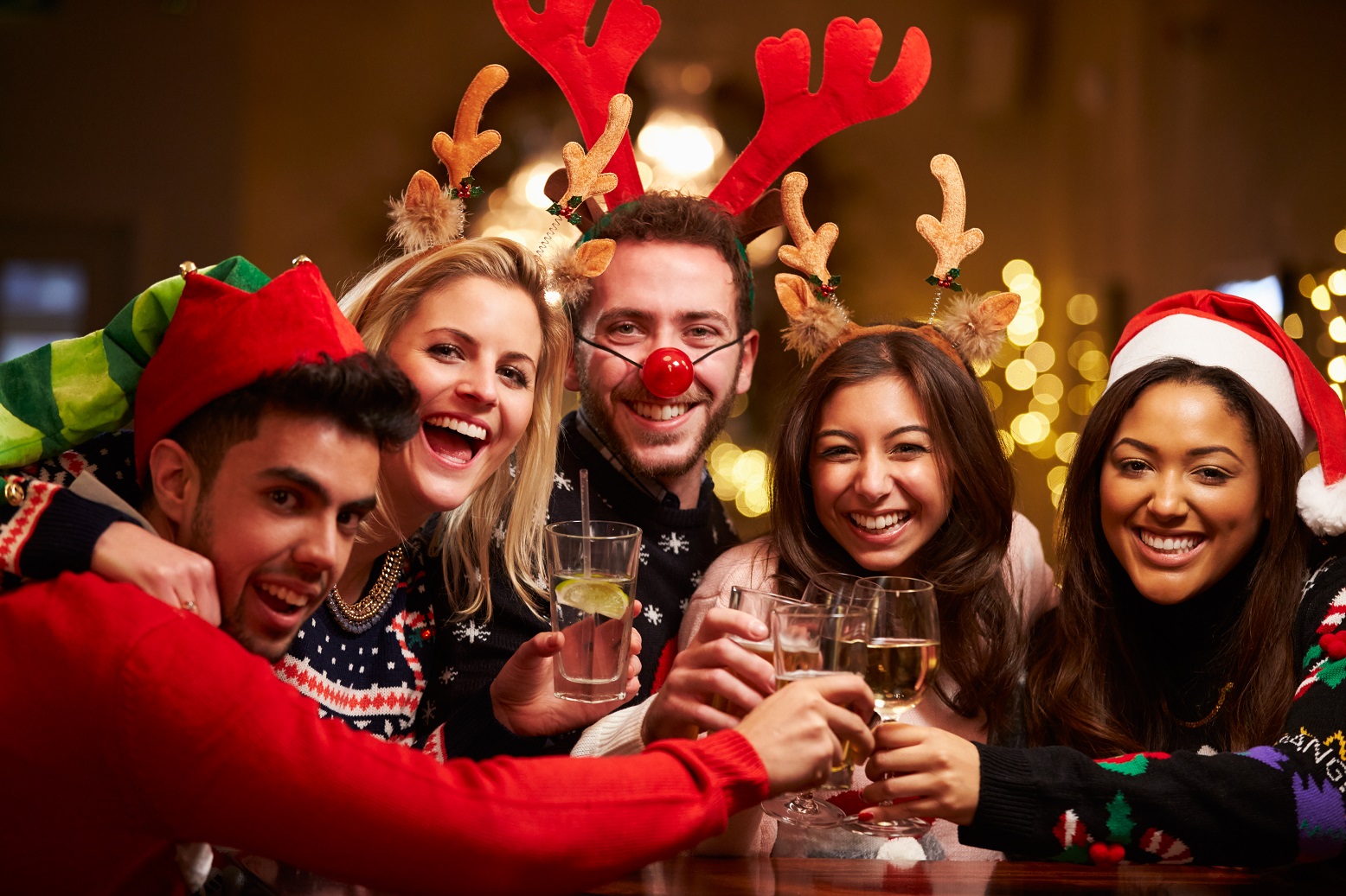 party Group Of Friends Enjoying Christmas Drinks In Bar