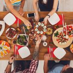 People eat healthy meals at festive table