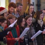 People sing carols at the Christmas Market