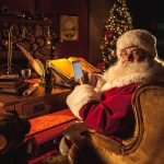 Santa Claus swiping a smart phone