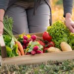 Woman Holding Crate With Vegetable