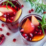 winter sangria with oranges, apples, pomegranate seeds, rosemary and spices