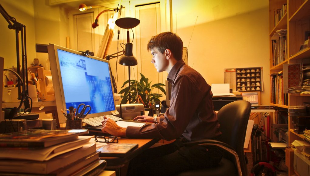 Young man at home using a computer working