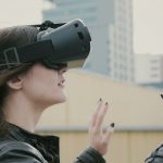 girl with waving hair uses 3D Virtual Reality headset