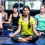 group doing yoga in gym