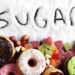 mix of sweet cakes, donuts and candy with sugar spread and written text