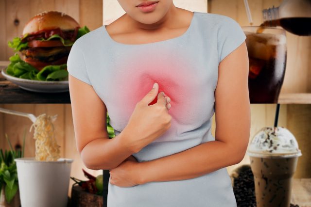 Woman with symptomatic acid reflux heartburn