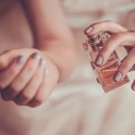 girl-applying-perfume-on-her-wrist-221862415