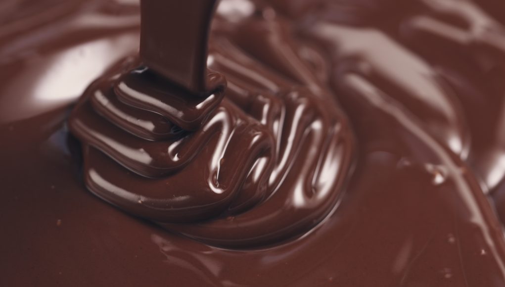 premium melted dark chocolate being poured healthy