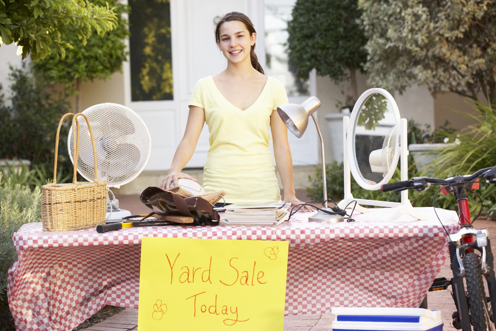 teenage-girl-holding-yard-sale