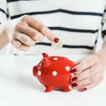 woman-saving-money-red-piggy-bank