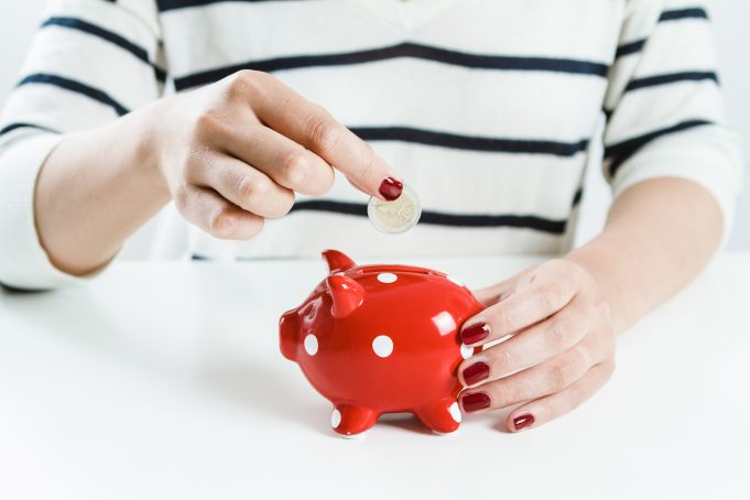 woman-saving-money-red-piggy-bank save