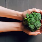 broccoli-hands-wooden-background-healthy-eating-526518475