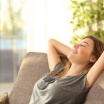 portrait-girl-relaxing-on-sofa-after-551904652