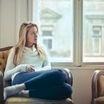 woman-home-window-thinking