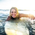 woman-surfing-beach-ocean-vacation