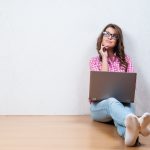 woman-laptop-sitting-hopeful-thinking