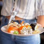 woman-holding-sushi-plate